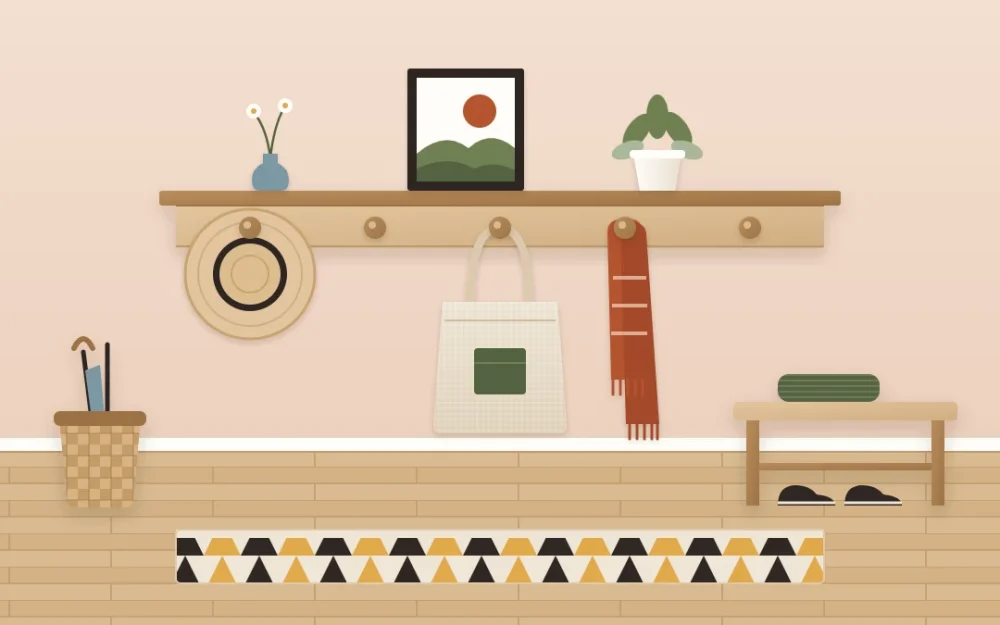 Wooden peg rail with a narrow shelf holding a straw hat, a canvas tote and a folded scarf, with a small plant and a framed print above