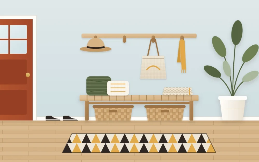 Slatted wooden entry bench with olive and cream cushions and a folded throw, two woven baskets underneath, a row of wooden hooks above and a tall plant beside it
