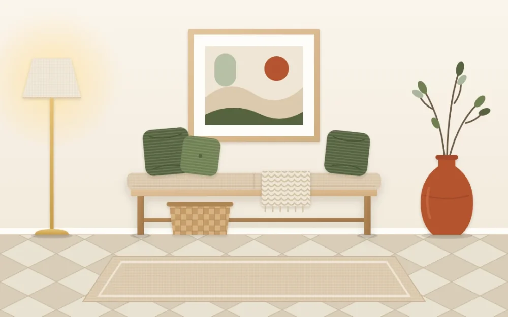 Entryway vignette with a cream wall, sand-colored bench and rug, olive green cushions, one terracotta vase and an abstract print above