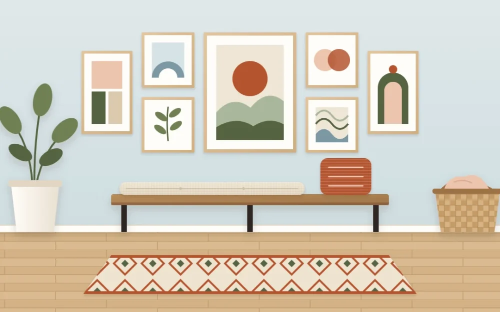 Entry wall with a tidy gallery of six abstract prints in matching thin oak frames arranged around one larger piece, above a low bench with a cushion
