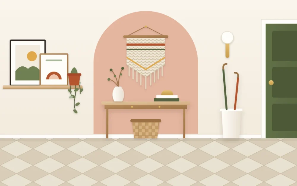 Entry wall with a soft terracotta painted arch behind a slim console, a woven hanging inside the arch, a picture ledge with two frames and a trailing plant