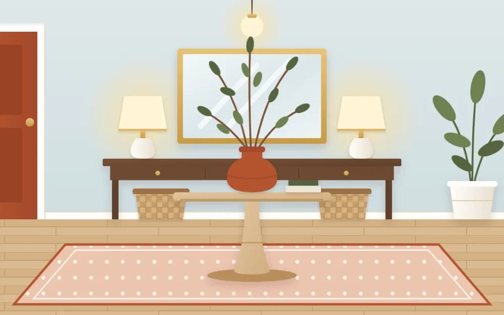 Spacious foyer with a round pedestal table on a large rug holding a vase of branches, and a long console with two lamps and a large mirror