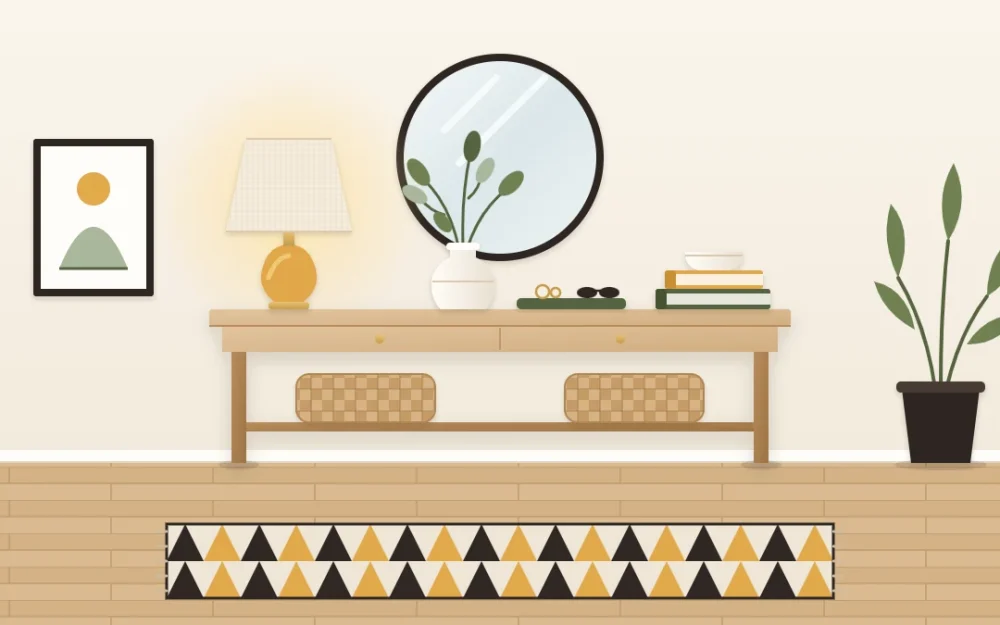 Styled oak console against a cream wall with a linen-shade lamp, a round mirror above, stacked books with a bowl, green stems and a small tray