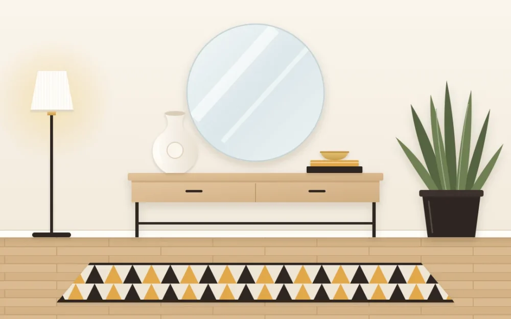 Modern entry with a pale wood console on slim black legs, a large frameless round mirror, a sculptural ceramic vase, an upright plant and a geometric rug
