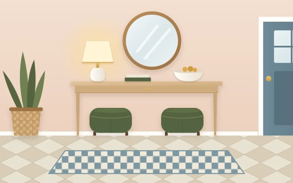 Tall-legged console table with two round olive upholstered stools tucked underneath, a lamp and bowl on top and a mirror above